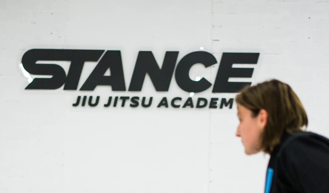 The Stance Jiu Jitsu Academy sign on the wall of the training space
